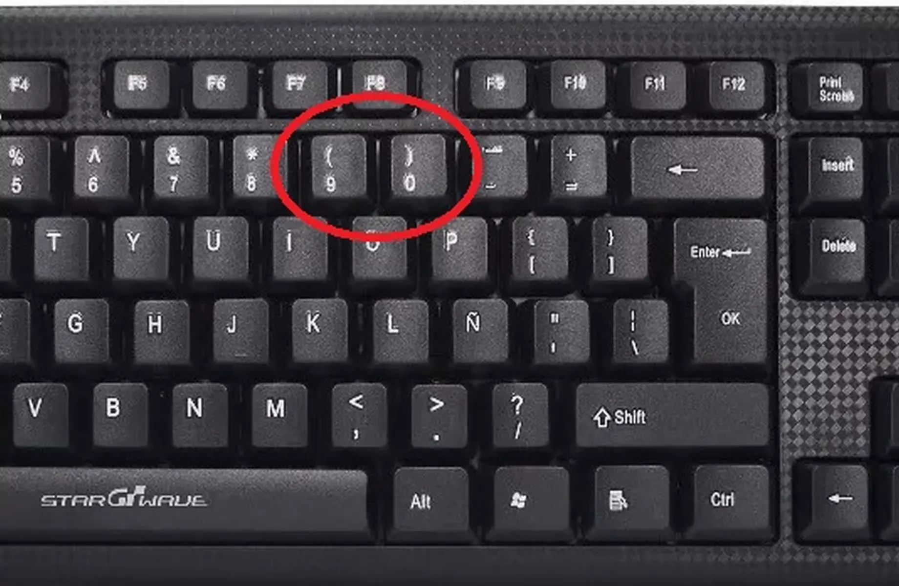 Cómo se escriben los paréntesis con el teclado?